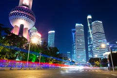 Street Traffic At Night In Shanghai, China. Office Skyscraper Buildings And Television Tower With Car Light Trails Royalty Free Stock Image Street Traffic At Night In Shanghai, China. Office Skyscraper Buildings And Television Tower With Car Light Trails Royalty Free Stock Image