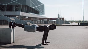 Street workout. Athletic African American man doing push-ups and spin exercise on outdoors. A black man is playing stock video Street workout. Athletic African American man doing push-ups and spin exercise on outdoors. A black man is playing stock video