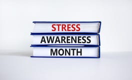 Stress awareness month symbol. Books with words `Stress awareness month`. Beautiful white background. Psychological, business an