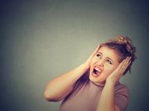 Stressed frustrated woman covering her ears Royalty Free Stock Image Stressed frustrated woman covering her ears Royalty Free Stock Image