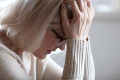 Sad tired senior woman holding head in hands feeling headache stock images Sad tired senior woman holding head in hands feeling headache stock images