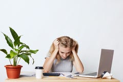 Stressful female working with figures, not knowing how to do business report, having panic, being focused on documents. Businesswo stock images Stressful female working with figures, not knowing how to do business report, having panic, being focused on documents. Businesswo stock images