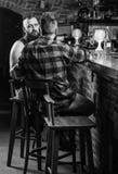 Strong alcohol drinks. Opening hours till last visitors. Friday relaxation in bar. Men relaxing at bar. Friends relaxing stock image Strong alcohol drinks. Opening hours till last visitors. Friday relaxation in bar. Men relaxing at bar. Friends relaxing stock image