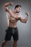 Strong Athletic Man shows body and abdominal muscles Royalty Free Stock Image Strong Athletic Man shows body and abdominal muscles Royalty Free Stock Image