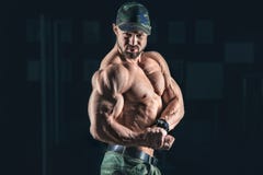 Strong bodybuilder athletic man pumping up muscles workout bodybuilding concept background stock photo Strong bodybuilder athletic man pumping up muscles workout bodybuilding concept background stock photo