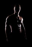 Strong, fit and sporty bodybuilder man over black background stock image Strong, fit and sporty bodybuilder man over black background stock image