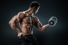 Strong and power bodybuilder doing exercises with dumbbell