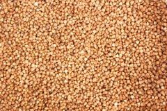 Struttura cruda del fondo dei grani del grano saraceno fotografia stock Struttura cruda del fondo dei grani del grano saraceno fotografia stock