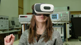 Student för ung kvinna med virtuell verklighetexponeringsglas i det fysiska laboratoriumet av universitetet Hon betraktar modelle arkivfilmer Student för ung kvinna med virtuell verklighetexponeringsglas i det fysiska laboratoriumet av universitetet Hon betraktar modelle arkivfilmer