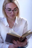 Student girl reading old book with glasses stock image Student girl reading old book with glasses stock image