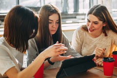 Students discussing media content using tablet Royalty Free Stock Images Students discussing media content using tablet Royalty Free Stock Images