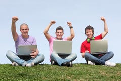 Students outdoors with laptops