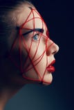 Studio beauty portrait of youg woman with red web royalty free stock image Studio beauty portrait of youg woman with red web royalty free stock image