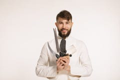 Studio shot of a happy bearded young chef holding sharp knives over white background. Chef with knife. Handsome smiling cheef hold stock images Studio shot of a happy bearded young chef holding sharp knives over white background. Chef with knife. Handsome smiling cheef hold stock images