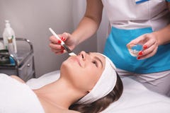 Stunning young woman with hair fixed behind, clean fresh skin naked shoulders wearing white bath robe and hair wrap stock photography Stunning young woman with hair fixed behind, clean fresh skin naked shoulders wearing white bath robe and hair wrap stock photography