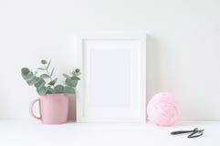 Styled mockup with white frame and pink ranunculos