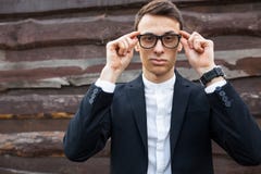 Stylish, beautiful, man in classic costume , posing near wooden wall. royalty free stock photos Stylish, beautiful, man in classic costume , posing near wooden wall. royalty free stock photos