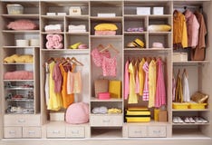 Stylish clothes, shoes and accessories in large closet