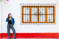 Stylish young woman posing against window outdoors. Fashionable outfit. stock photos Stylish young woman posing against window outdoors. Fashionable outfit. stock photos