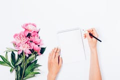 Stylized feminine desk with bouquet of fresh light pink peonies royalty free stock photo Stylized feminine desk with bouquet of fresh light pink peonies royalty free stock photo