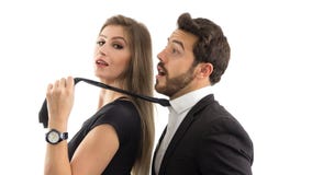 Wife pulls her husband by the tie. She is smiling. Submissive husband.. stock photography Wife pulls her husband by the tie. She is smiling. Submissive husband.. stock photography