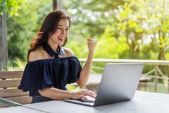 Successful woman using laptop with arms raised stock photos Successful woman using laptop with arms raised stock photos