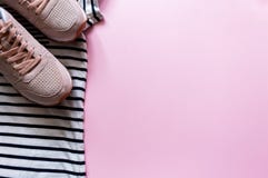 Summer beach travel clothes and pink leather sneakers. Flatlay of a trendy woman fashion outfit. Sport clothes. stock photography Summer beach travel clothes and pink leather sneakers. Flatlay of a trendy woman fashion outfit. Sport clothes. stock photography