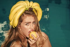 Summer vacation and travel to ocean. woman with tropical fruit in pool. Vitamin in banana at girl near water stock photo Summer vacation and travel to ocean. woman with tropical fruit in pool. Vitamin in banana at girl near water stock photo