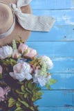 Sun hat and flowers on blue wooden plank background. Holiday and stock photos Sun hat and flowers on blue wooden plank background. Holiday and stock photos