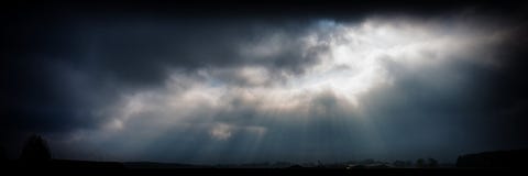 Sun`s Rays Against The Sky Covered With Dark Rain Clouds Royalty Free Stock Image