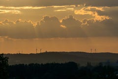 Sunbeams of the sunset hitting some wind turbines stock photos Sunbeams of the sunset hitting some wind turbines stock photos