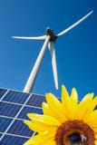 Sunflower, blue solar cells and wind turbine stock images Sunflower, blue solar cells and wind turbine stock images