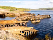 Sunken old wooden fishing boats in Teriberka, Murmansk Oblast, Russia stock photo Sunken old wooden fishing boats in Teriberka, Murmansk Oblast, Russia stock photo