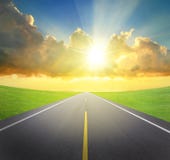 Sunrise with asphalt road and green grass stock images Sunrise with asphalt road and green grass stock images