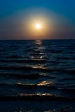 Sunrise on blue sky and dark sea in the morning dawn Royalty Free Stock Photos Sunrise on blue sky and dark sea in the morning dawn Royalty Free Stock Photos