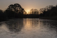 Sunrise on an icy morning at the Ornamental Pond, Southampton Common Stock Photo Sunrise on an icy morning at the Ornamental Pond, Southampton Common Stock Photo