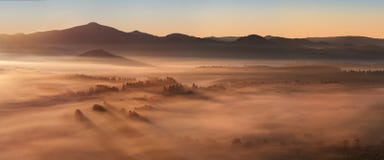 Sunrise Over Misty Landscape. Scenic View Of Foggy Morning Sky With Rising Sun Above Misty Forest. Stock Images
