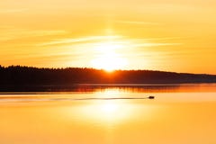 Sunset Behind Forest And With Floating Boat On River. Stock Photos