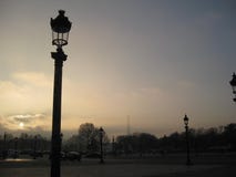 A sunset behind some gorgeous Parisien street lamps with the Eiffel Tower in the background, Paris royalty free stock image A sunset behind some gorgeous Parisien street lamps with the Eiffel Tower in the background, Paris royalty free stock image