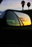 Sunset clouds reflected car mirror
