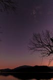 Sunset on a lake with mountains in the background. stock photos Sunset on a lake with mountains in the background. stock photos