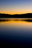 Sunset on lake reflection. Sunset over the lake with trees reflecting in the water Sunset on lake reflection. Sunset over the lake with trees reflecting in the water