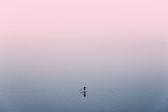 SUP Surfing,View From Above: Lonely Man Is Training On Sup Board On A Large Lake During Pinky Sunset. Surfer.Man In Red Jacket St