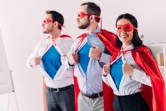 super businesspeople in masks and capes showing blue shirts stock photo super businesspeople in masks and capes showing blue shirts stock photo