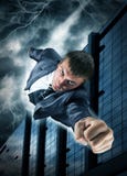 Superhero businessman flying over downtown royalty free stock photography Superhero businessman flying over downtown royalty free stock photography