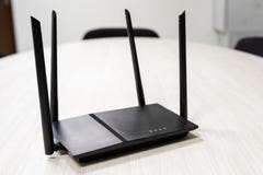 Sur la table est un routeur foncé de Wi-Fi pour accéder à l'Internet image stock Sur la table est un routeur foncé de Wi-Fi pour accéder à l'Internet image stock