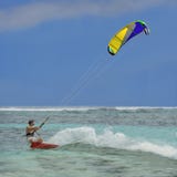 Surfer. Speed, splashes, colorful kite