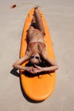 Surfer girl posing with her surfboard on the beach stock images Surfer girl posing with her surfboard on the beach stock images