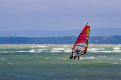 Surfer with red windsurf surrounded with waves - Lake Balaton