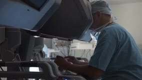 Surgeon operating robotic surgery machine, Minimally Invasive Da Vinci System